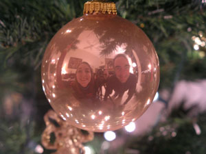 us reflected in a christmas ornament